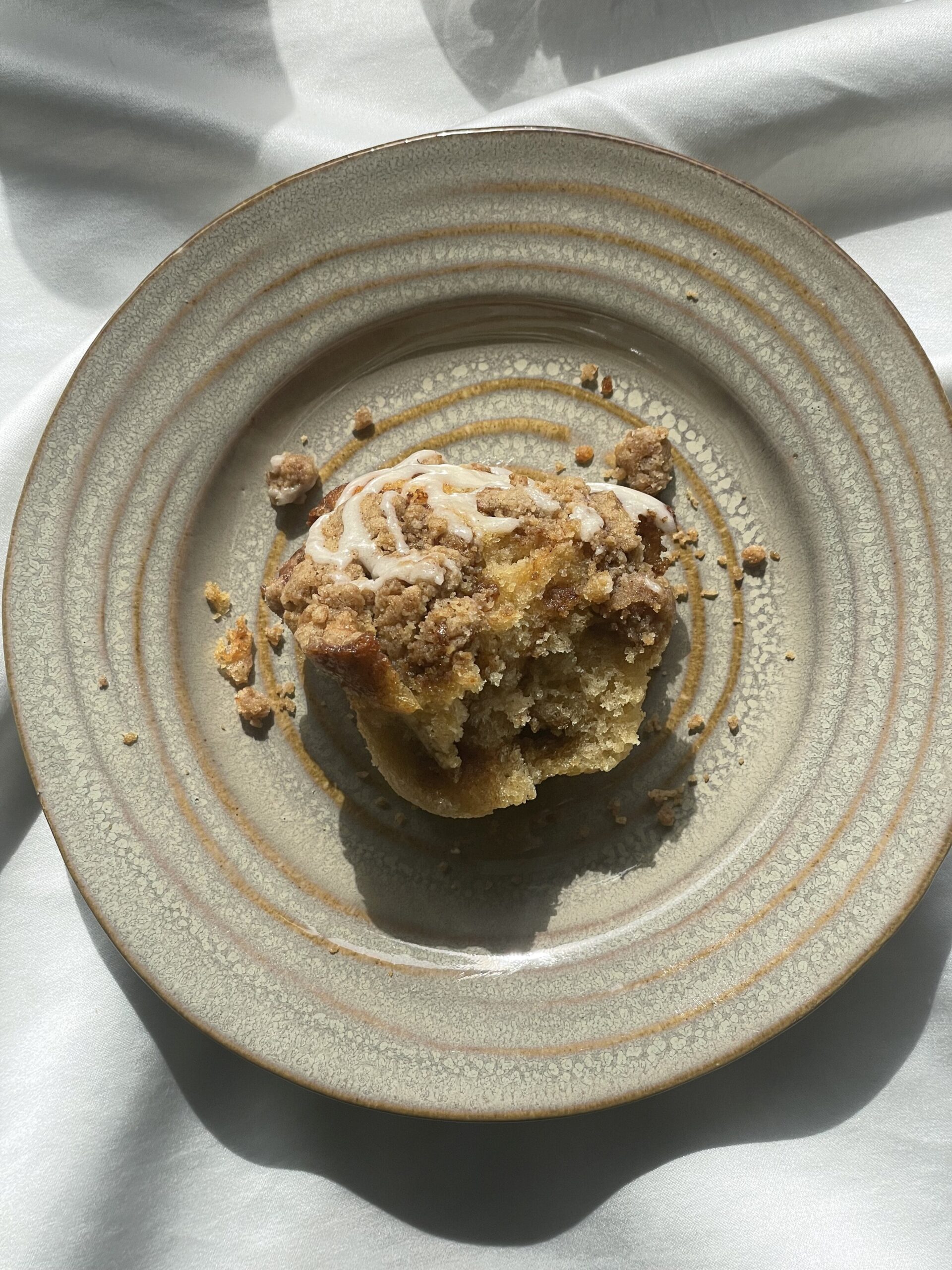 Cinnamon roll muffins with brown butter crumble and frosting